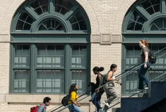 Students walking up outdoor stairs with backpacks